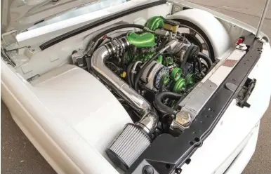  ??  ?? ABOVE. IT’S SO CLEAN! A TON OF WORK WENT INTO GETTING THE ENGINE COMPARTMEN­T SO TIDY, INCLUDING CUSTOM WHEEL TUBS AND A WHOLE LOT OF WIRE TUCKING. THE GREEN ACCENTS ON THE ENGINE GIVE THE PERFECT AMOUNT OF POP AGAINST THE BMW ALPINE WHITE PAINT.