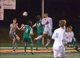  ?? PAUL DICICCO — THE NEWS-HERALD ?? University’s George Nageeb tries to direct a header during the Preppers’ Division I district final win over Lake Catholic.