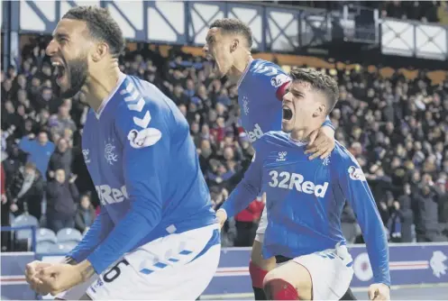  ??  ?? 0 From left to right, Connor Goldson, James Tavernier and Ianis Hagi celebrate the latter’s winning goal against Hibs on Wednesday.