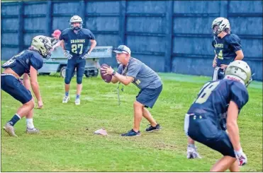  ?? Steven Eckhoff ?? Pepperell head coach Rick Hurst (center) runs a drill with several players during a recent preseason practice.