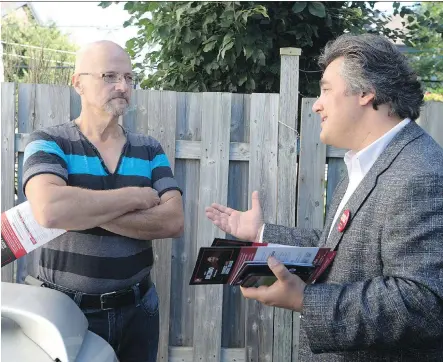  ?? CHRISTINNE MUSCHI FOR NATIONAL POST ?? Liberal candidate Angelo Iacono, right, speaks with Laval resident Michel Latour on Saturday. Iacono was canvassing the Alfred- Pellan riding, which is currently held by the NDP’s Rosane Dore Lefebvre.