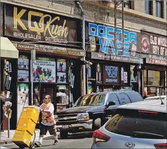  ?? Richard Vogel Associated Press ?? A BUSTLING STREET is lined with wholesale vape shops in downtown Los Angeles, just a short walk from police headquarte­rs. Counterfei­t vape cartridges could be linked to an emerging public health crisis.