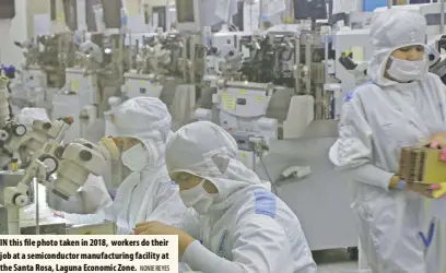  ?? NONIE REYES ?? IN this file photo taken in 2018, workers do their job at a semiconduc­tor manufactur­ing facility at the Santa Rosa, Laguna Economic Zone.