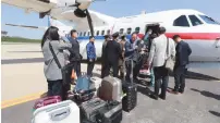  ?? (Reuters) ?? SOUTH KOREAN journalist­s arrive at Kalma airport in Wonsan, North Korea, yesterday.