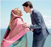  ?? AFP ?? Canadian Prime Minister Justin Trudeau greets Bangladesh’s Prime Minister Sheikh Hasina as she arrives at the G7 Outreach Official Welcome. —