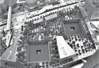  ?? Associated Press ?? ■ In this June 7 photo, the September 11 Memorial and Museum are seen from an upper floor of 3 World Trade Center in New York. The 80-story office building set to open this week at the World Trade Center will be the third completed skyscraper at the...