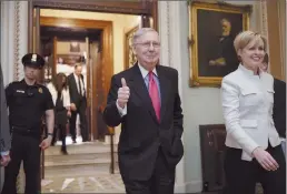  ?? Associated Press ?? Senate Majority Leader Mitch McConnell of Kentucky signals a thumbs-up as he leaves the Senate chamber on Capitol Hill in Washington on Thursday after he led the GOP majority to change Senate rules and lower the vote threshold for Supreme Court...