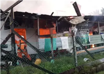  ??  ?? A fireman is seen battling the flames at the affected house.