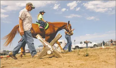  ?? NEWS-SENTINEL FILE PHOTOGRAPH ?? Lilyann Arroz, 6, of Galt, rides as Dick Schauer walks besides her during the Galt Horse Assisted Learning & Enrichment Program’s (GALEP) therapeuti­c riding program in Galt on July 30, 2014. The Galt Joint Union Elementary School District is restarting...