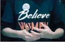  ?? The Associated Press ?? A woman wears a shirt that reads “Believe Women” with a button that reads “I Believe Dr. Christine Blasey Ford” as protesters against Supreme Court nominee Brett Kavanaugh tell their personal stories of sexual assault.