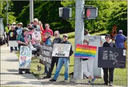  ?? SEAN D. ELLIOT THE DAY ?? A small group of protesters gathers Wednesday at Williams Street and Mohegan Avenue outside the Coast Guard Academy, where Vice President Mike Pence delivered the keynote address.