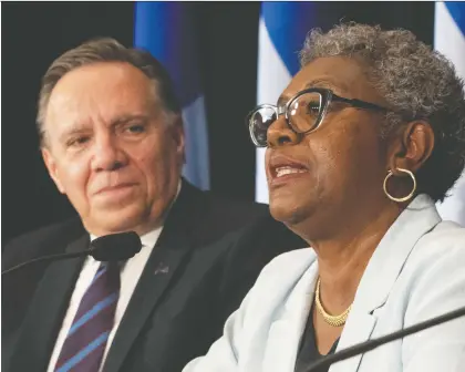  ?? JACQUES BOISSINOT/THE CANADIAN PRESS ?? “I am determined to identify concrete solutions for our children,” said Régine Laurent, as she was introduced by Quebec Premier François Legault as head of a commission looking into the youth-protection system.