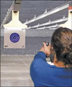  ?? Staff photo/Bob Tomaszewsk­i ?? Democratic candidate for the Fourth Congressio­nal District Shannon Freshour takes aim at a target in the firing range at Midwest Shooting Center. Freshour and Auglaize County Democrats held an education session at the shooting center on Saturday.