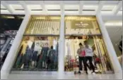  ?? THE ASSOCIATED PRESS ?? Shoppers leave a Kate Spade store in New York on Monday. Coach will spend $2.4 billion for Kate Spade.