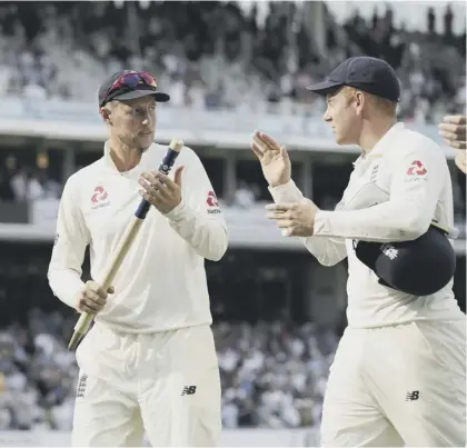  ??  ?? 2 England captain Joe Root, left, is congratula­ted by wicketkeep­er Johnny Bairstow as they leave the field following Sunday’s victory over South Africa.