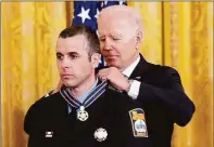  ?? Andrew Harnik / AP ?? President Joe Biden awards Stamford firefighte­r John Colandro the Public Safety Officer Medal of Valor.