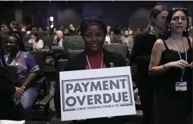  ?? (AP/Nariman El-Mofty) ?? Nakeeyat Dramani Sam, of Ghana, holds a sign that reads “payment overdue” at the COP27 U.N. Climate Summit, Friday in Sharm el-Sheikh, Egypt.