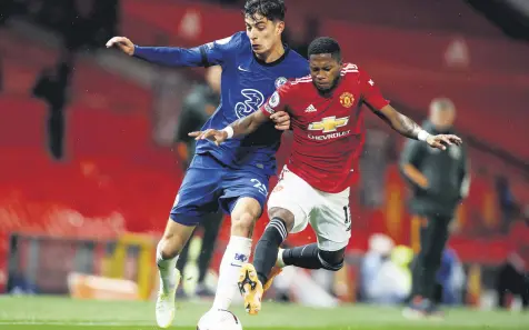  ??  ?? Chelsea’s Kai Havertz (L) duels for the ball with Manchester United’s Fred during a Premier League match at the Old Trafford stadium in Manchester, England, Oct. 24, 2020.