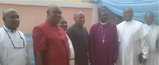  ??  ?? Chairman, Franjane Royal Suites Hotel, Francis Okeke (2nd left) dressed in red French suit, standing with members of the clergymen during the inaugurati­on of the hotel in Okota, Lagos...recently(1).jpg