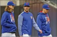  ?? KATHY WILLENS — THE ASSOCIATED PRESS ?? New York Mets starting pitchers Noah Syndergaar­d, left, and Matt Harvey, center, walk to the dugout before the team’s baseball game against the San Francisco Giants, Tuesday. Before the game, Harvey publicly apologized for skipping out on a game last...