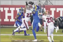  ??  ?? San Francisco 49ers cornerback Jason Verrett (22) intercepts a pass in the end zone between Los Angeles Rams wide receiver RobertWood­s, left, and Josh Reynolds during the second half in Santa Clara on Sunday.