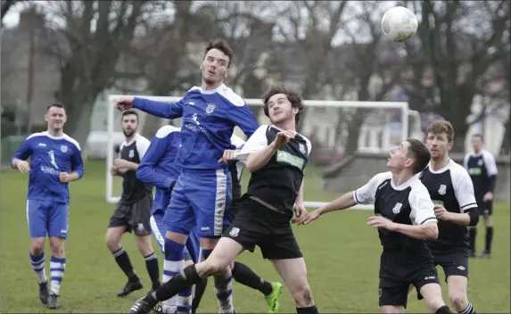  ??  ?? Anto Byrne of Ashford Rovers gets his head to the ball ahead of Evan Moran of Newtown United.