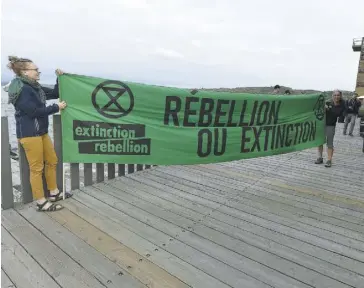  ?? PHOTO JEAN-FRANÇOIS DESGAGNÉS ?? Deux militantes du mouvement social Extinction Rebellion ont profité du passage du chef conservate­ur Andrew Scheer à Québec pour exiger un changement radical en environnem­ent afin de limiter le réchauffem­ent climatique.