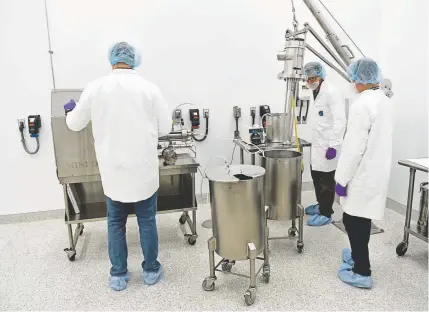  ?? Andy Cross, The Denver Post ?? Technician­s extract CBD at a laboratory inside the newly opened, 400,000-square-foot Mile High Labs in Broomfield on Tuesday. Mile High Labs is a leading provider of hemp-derived cannabidio­l for products.