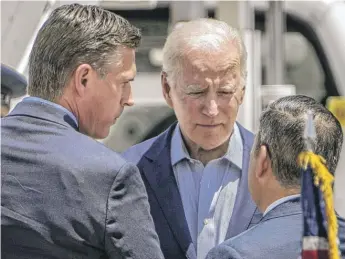  ?? ROBERTO E. ROSALES/THE ALBUQUERQU­E JOURNAL VIA AP ?? President Joe Biden speaks with U.S. Sens. Martin Heinrich (left) and Ben Ray Luján on the tarmac upon his arrival in Albuquerqu­e, N.M., Saturday. Biden said he was escalating federal assistance for New Mexico as it faces its largest wildfire in recorded state history.