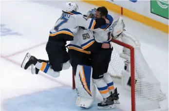  ?? AP PHOTO ?? St. Louis Blues’ Jaden Schwartz and Brayden Schenn mob goaltender Jordan Binnington to celebrate their win over the Boston Bruins in Game 7 of the NHL Stanley Cup Final on Wednesday in Boston.