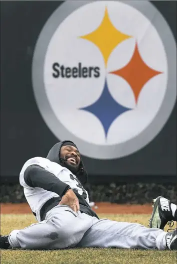  ?? Peter Diana/Post-Gazette photos ?? Running back DeAngelo Williams shares a laugh while stretching before the start of workouts Wednesday at the Steelers practice facility on the South Side.