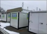  ?? RICHARD PAYERCHIN — THE MORNING JOURNAL ?? Portable storage boxes sit outside a business building Tuesday on Oberlin Avenue in Lorain. Lorain City Council will consider rules limiting the time residents may keep portable storage units on their property.