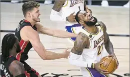  ??  ?? L e BRON JAMES had a near triple- double with 25 points against Meyers Leonard and the Heat, but he also had eight of the Lakers’ 20 turnovers.