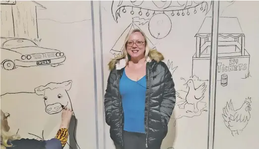  ?? COURTESY PHOTO ?? Director Lucia Hanover watches as designer Cynthia Stamps creates the whimsical set for RAAC Community Theatre’s holiday season production of Charlotte’s Web.