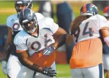  ?? Joe Amon, The Denver Post ?? Shelby Harris (96) works on a move with starting nose tackle Domata Peko, right, during training camp Wednesday.