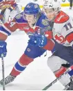  ?? POSTMEDIA ?? Edmonton Oil Kings Logan Dowhaniuk (24) and Lethbridge Hurricanes Dino Kambeitz (11) fight for the puck during WHL action at Rogers Place in Edmonton on Feb. 26.