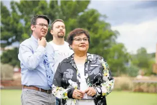  ?? GABRIELA CAMPOS/THE NEW MEXICAN ?? Cecelia Cervantes, interim president of Santa Fe Community College, and her team members Todd Eric Lovato, left, executive director of marketing and public relations, and Marcos Maez, director of student recruitmen­t and outreach, walk the grounds of the former Santa Fe University of Art and Design. They were in preparing for a family movie night the college is co-sponsoring with the city of Santa Fe on July 14. The free screening of 1971’s Willy Wonka and the Chocolate Factory will also feature food trucks and other events.