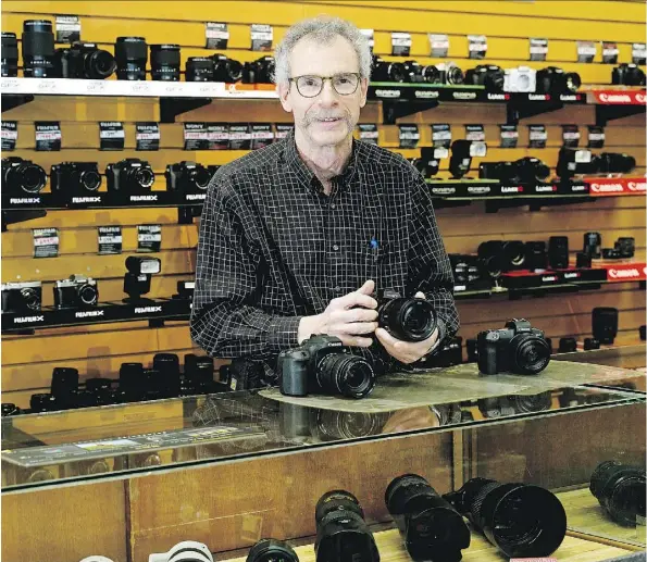  ?? LARRY WONG ?? Neil McBain, former owner of the 70-year-old McBain Camera store chain in Alberta, has sold the company to London Drugs.