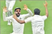  ?? AFP ?? ■ Captain Virat Kohli celebrates with Ravichandr­an Ashwin after India beat Australia on day 5 of the Adelaide Test on Monday