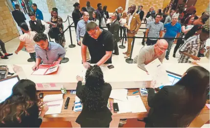  ?? Wilfredo Lee, The Associated Press ?? Job applicants submit their résumés at the Seminole Hard Rock Hotel & Casino during a job fair in Hollywood, Fla., in June. Unemployme­nt in the U.S. remains near a half-century low at 3.7%.