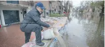  ?? PETER MCCABE ?? Gianni Crivello works to keep water from his basement on rue Cousineau in Cartiervil­le-Ahuntsic on Sunday.