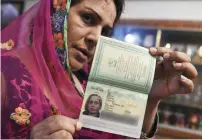  ?? AFP ?? Transgende­r Farzana Riaz displays her newly-obtained passport in Peshawar. —