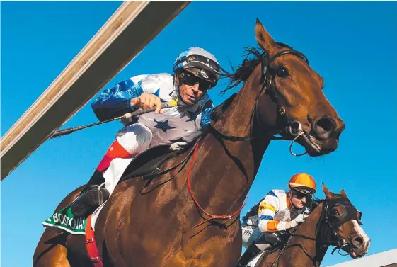  ?? Picture: ALBERT PEREZ/AAP IMAGE ?? Michael Cahill rides The Bostonian to victory in the Doomben 10,000 at Brisbane earlier this month.