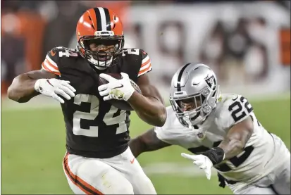  ?? DAVID RICHARD — THE ASSOCIATED PRESS ?? Cleveland Browns running back Nick Chubb (24) runs for a first down as Las Vegas Raiders defensive back Keisean Nixon (22) reaches for him during the second half of an NFL football game, Monday in Cleveland.
