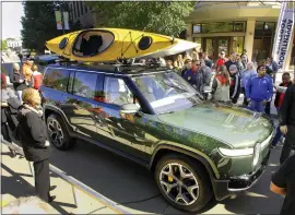  ?? DAVID PROEBER — THE PANTAGRAPH VIA AP ?? Large crowds turned out to look at Rivian Automotive’s R1S prototype during a public rollout of the company’s new vehicles in Normal, Illinois, in 2019.