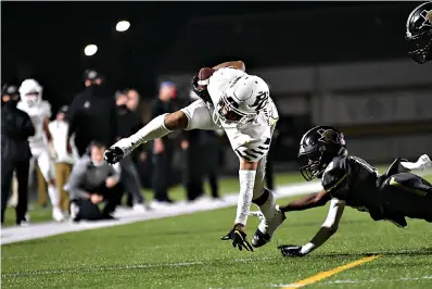  ?? Photo by Kevin Sutton ?? ■ Pleasant Grove’s R.J. Collins leaps toward the goal line Friday night against Pittsburg. The Hawks won their district opener, 48-9.