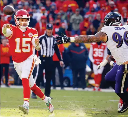  ?? CHARLIE RIEDEL/THE ASSOCIATED PRESS ?? Kansas City Chiefs quarterbac­k Patrick Mahomes, being pursued by Baltimore Ravens defensive end Brent Urban Sunday at Arrowhead Stadium, threw for 377 yards and two touchdowns as the Chiefs clinched a playoff spot with a 27-24 overtime win.