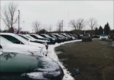  ?? MIKE HOUSEHOLDE­R — THE ASSOCIATED PRESS ?? In this image made from video, cars drive through the used vehicle lot at a LaFontaine auto dealership in Fenton Township, Mich., recently. A chain reaction touched off by the coronaviru­s pandemic has pushed new-vehicle prices to record highs and dramatical­ly driven up the cost of used ones.