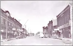  ?? (Courtesy Photo/Rogers Historical Museum) ?? This is Walnut Street at the time Tom Hughes lived here in the 1940s. Sterlings Five & Dime, Cole’s Drug Store, Western Auto, and many other businesses are shown in the photo.