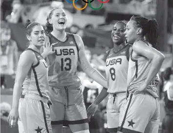  ?? JEFF ROBERSON AP ?? The U.S. team (from left) of Kelsey Plum, Stefanie Dolson, Jacquelyn Young and Allisha Gray celebrate after defeating Russia in the women's 3-on-3 basketball gold medal game on Wednesday. ‘It feels surreal,’ Dolson said.
